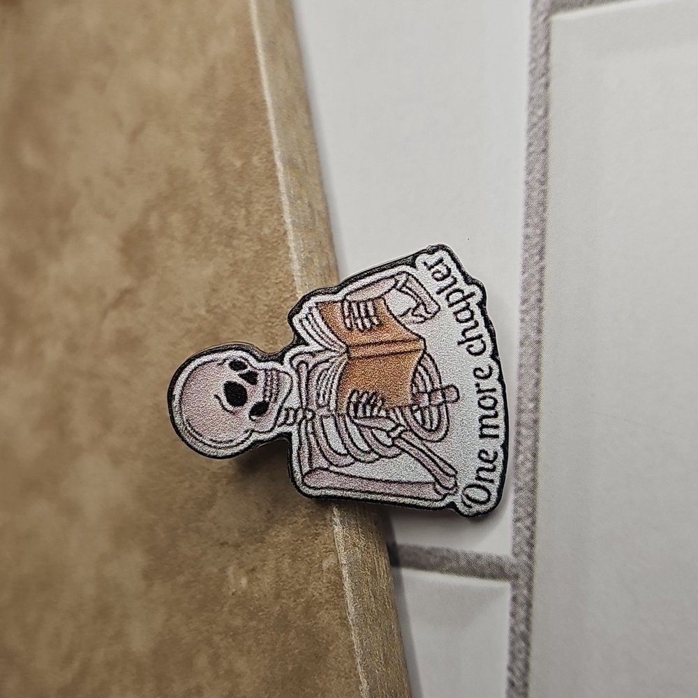 Skeleton Reading 'One More Chapter'Pin